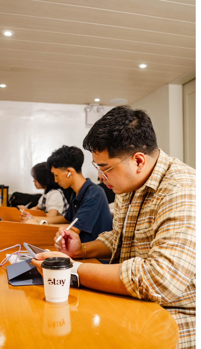 Branch 1 — focused work at the bar with branded café stay cup