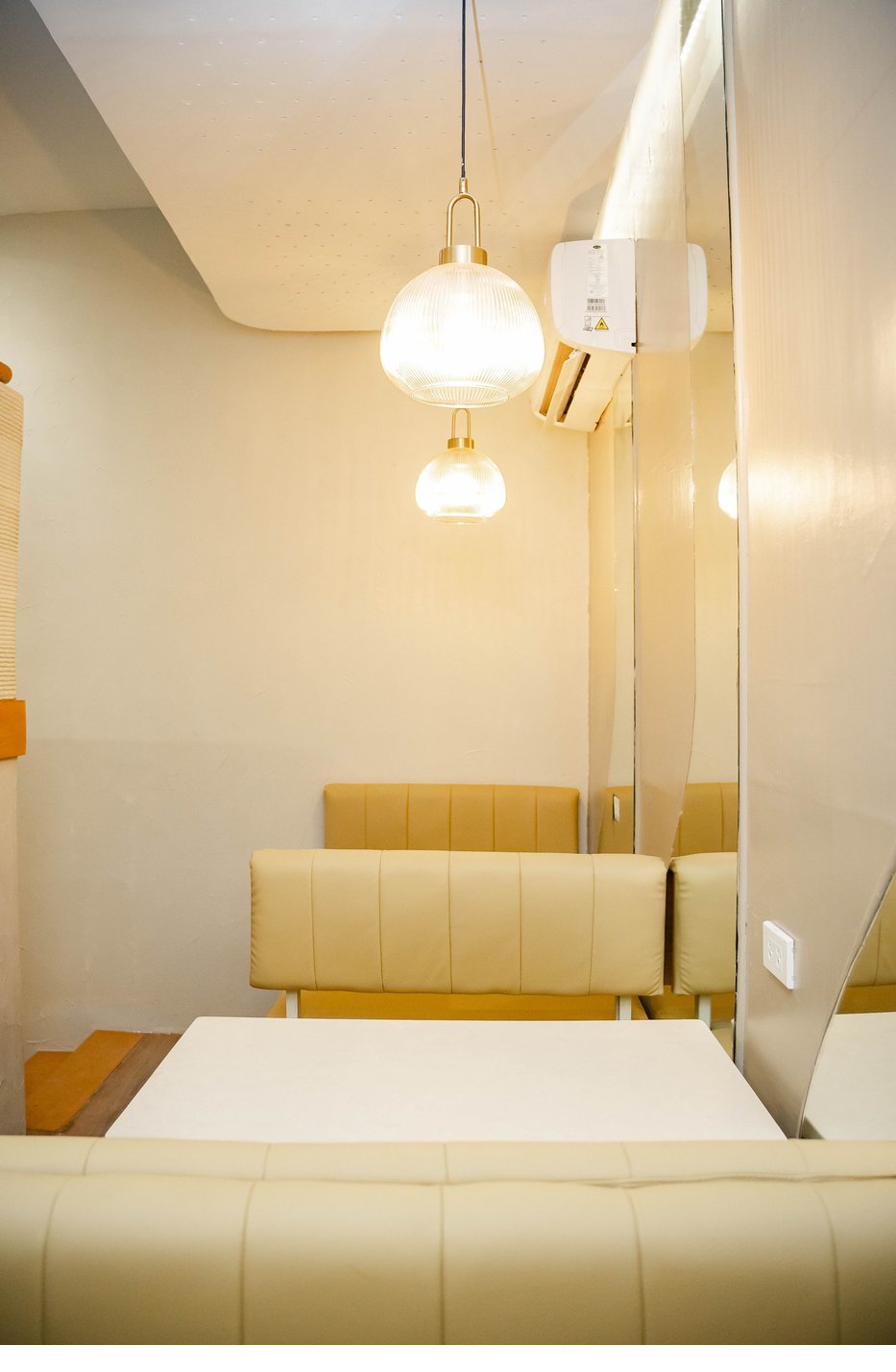 Pendant light fixtures above the booths