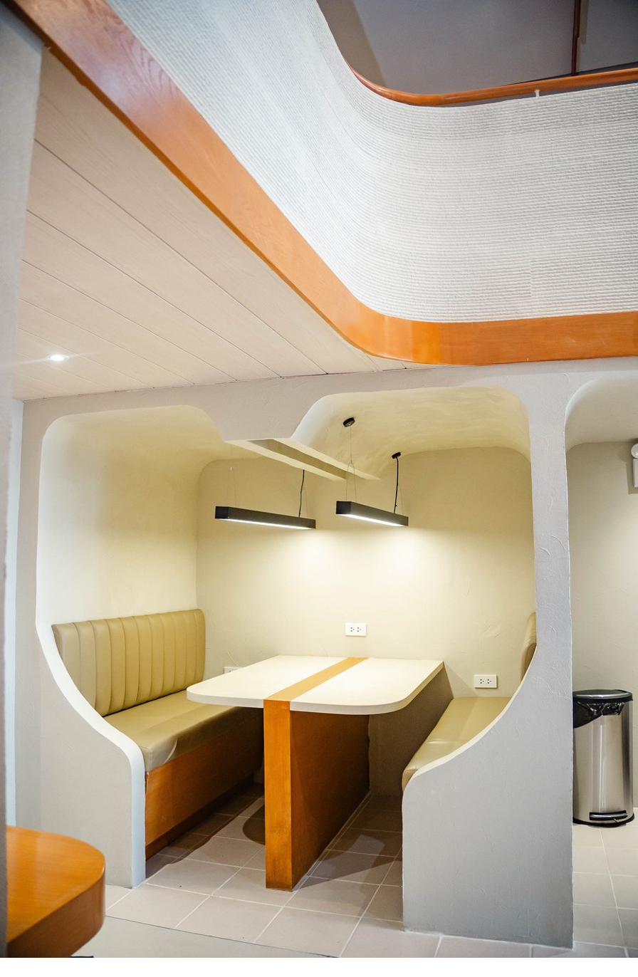 Solo pod with warm wood paneling and textured plaster