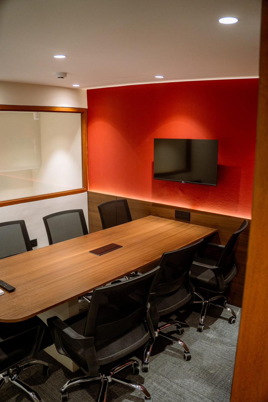 Seven-seater red meeting room with TV