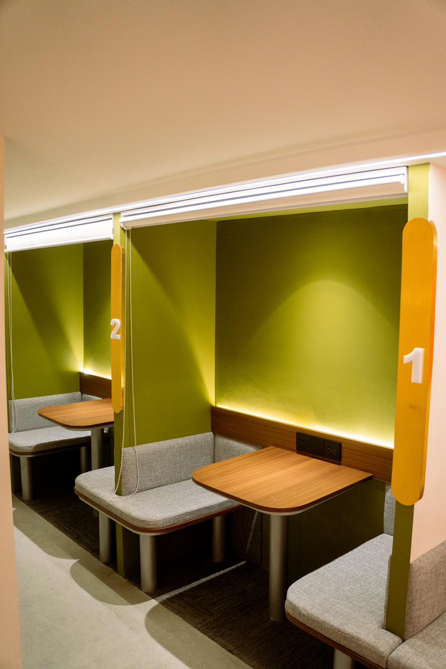 Two green 2-seater booths in a row