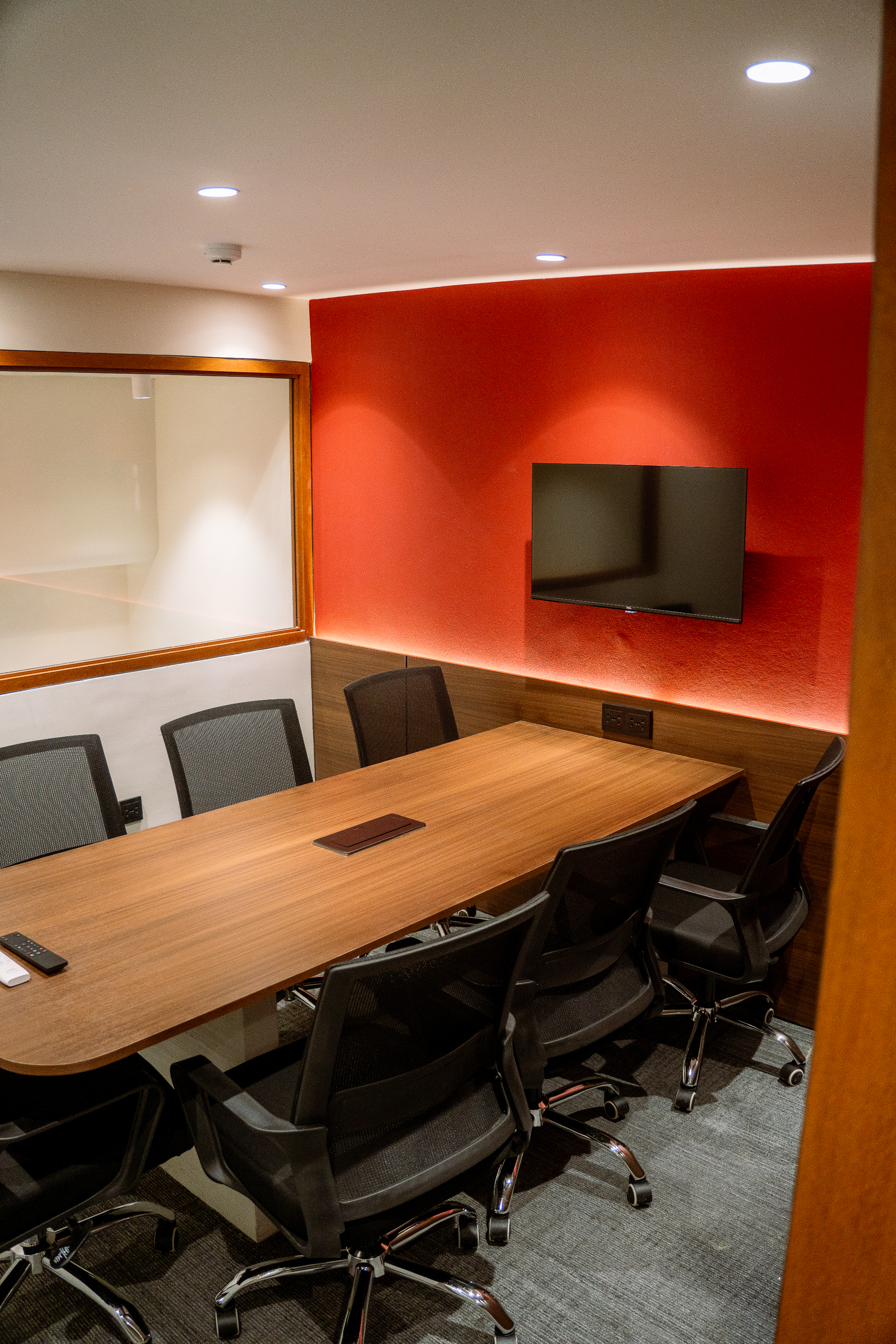 7-seater red conference room — wide view